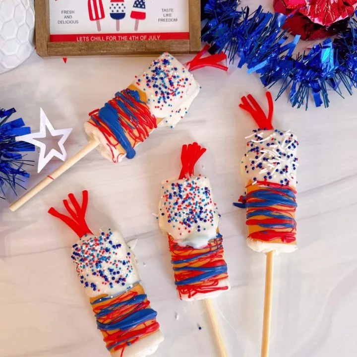Firecracker Swiss Roll Cake Pops on a table decorated and ready to eat!