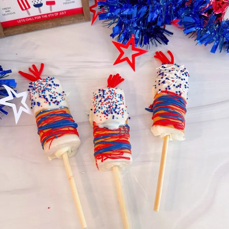 4th of July Firecracker Cake Pops on a white counter ready to eat.