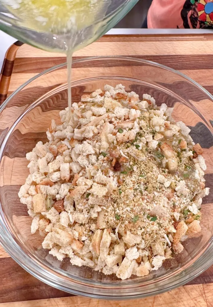 Mixing the stuffing with melted butter in a medium bowl.