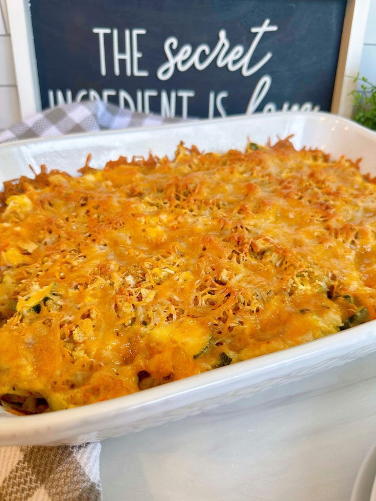 Whole chicken zucchini casserole in a white baking dish.