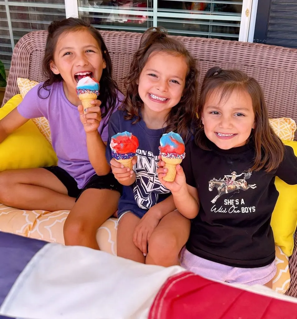 Kids eating ice cream cones for 4th of July.