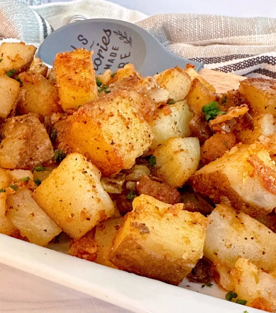 Close up photo of ranch potatoes fried in a skillet.