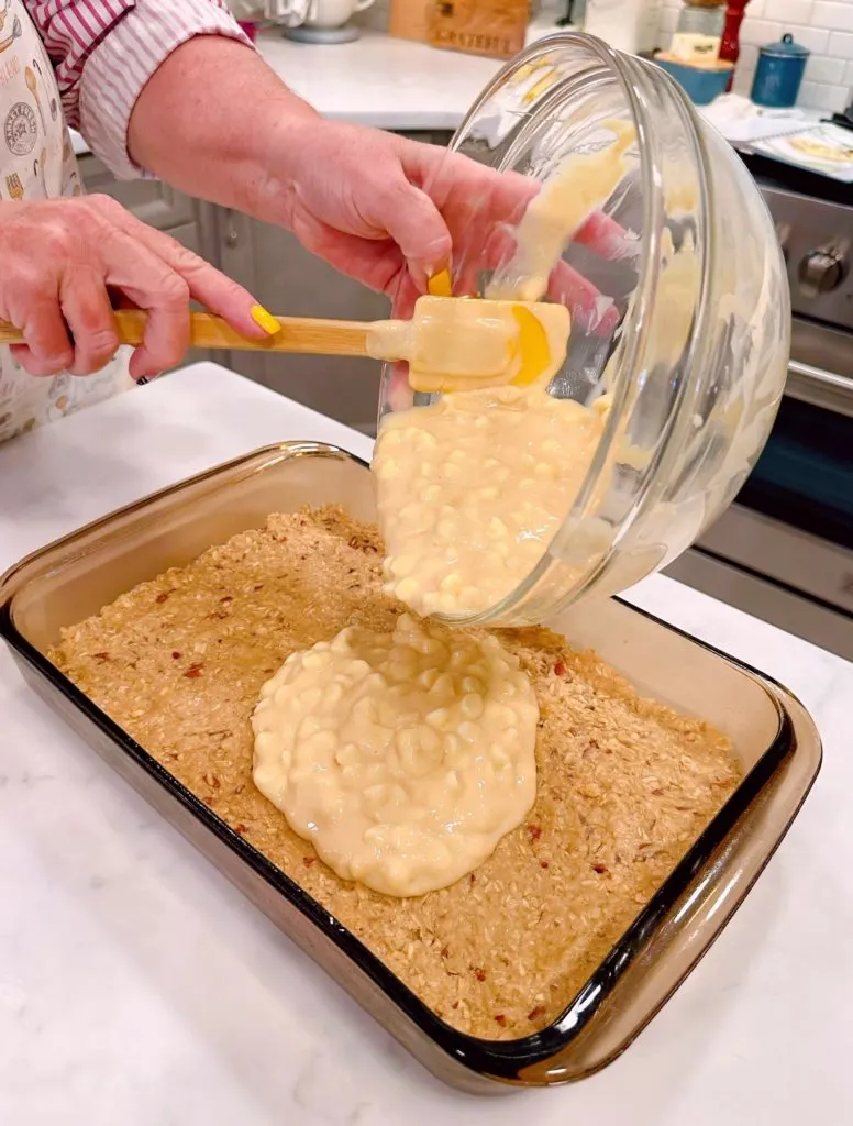 Adding Lemon Cream filling mixture to lemon bars.