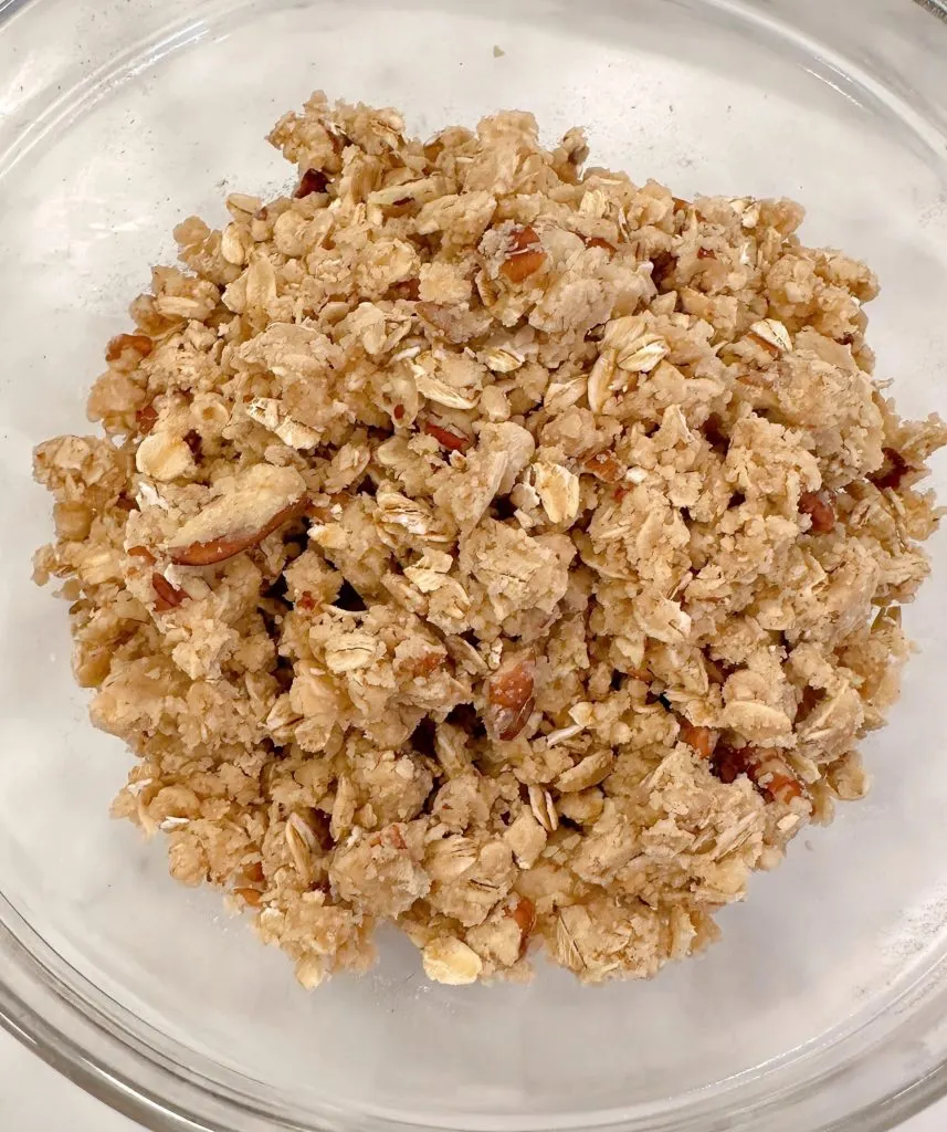 Reserved crumb topping in a medium bowl.