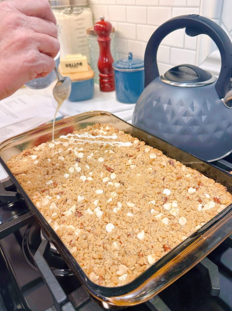 Drizzling melted white chips over the top of the lemon bars.