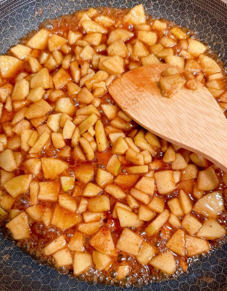 Apples cooking in spices and brown sugar.