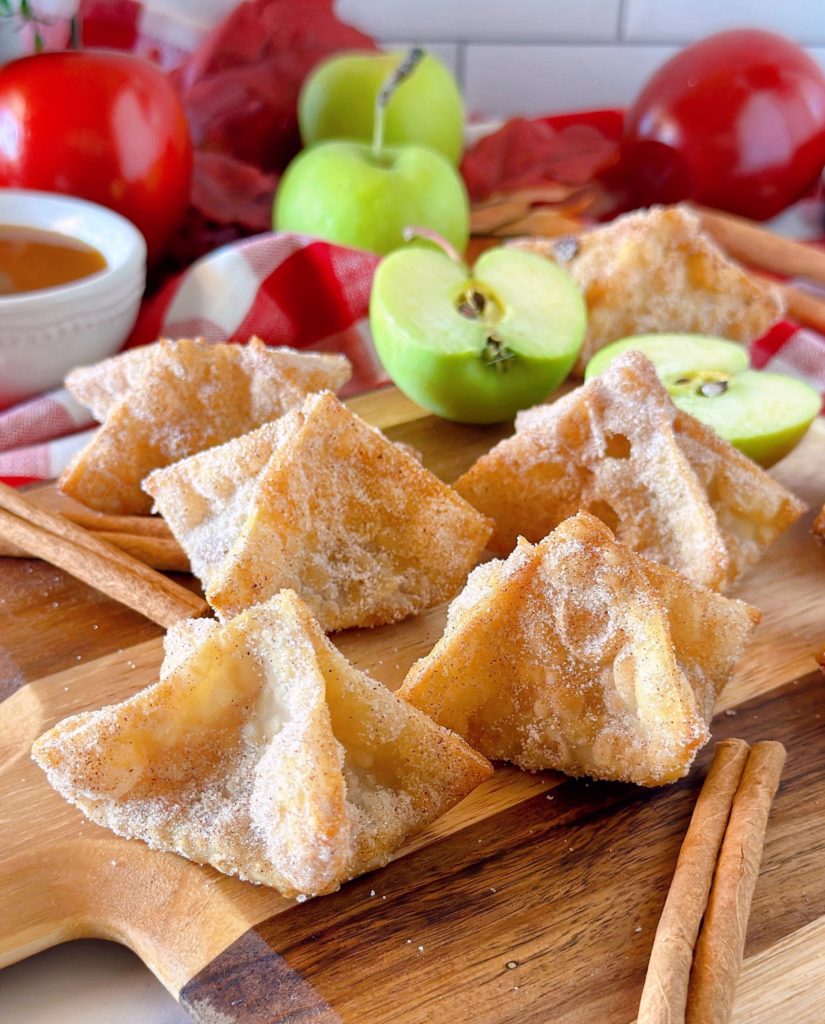 Fried Wonton Apple Pie Bites with apples and cinnamon sticks. Ready to eat.