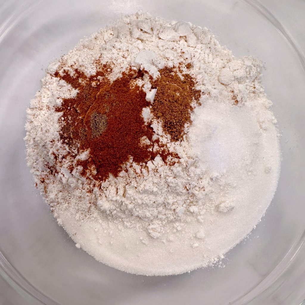 Mixing together dry ingredients for the peach pie filling in a bowl.