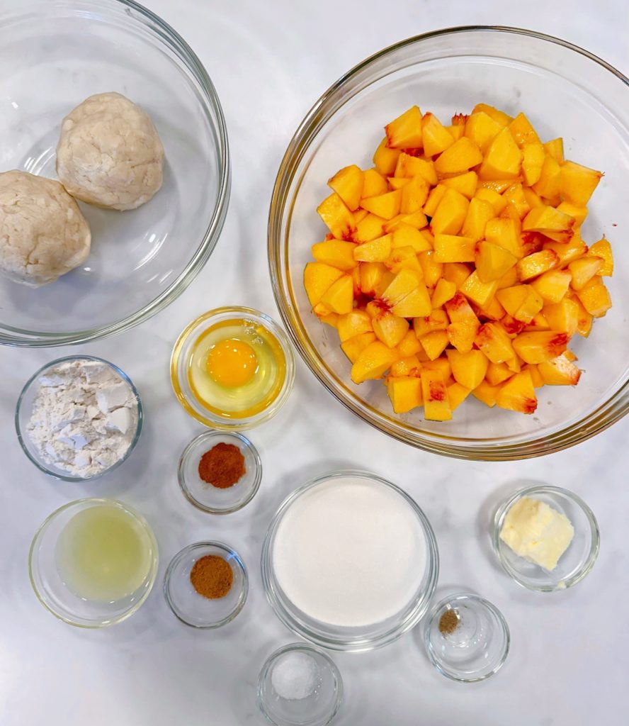 Ingredients for Baked peach pie on a white counter top.