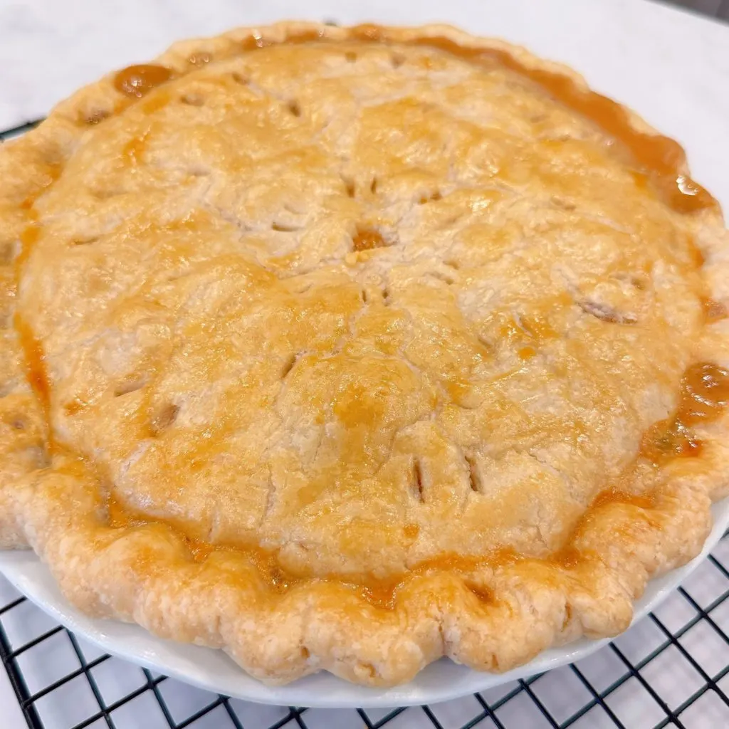 The pie cooling on a cooling rack.