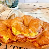 Easy Croissant Breakfast Sandwiches on a cutting board.