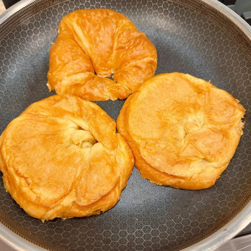 Toasting Croissant Rolls in large skillet over medium-high heat.