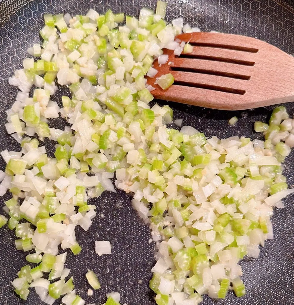 Sauting celery, onion, and garlic in butter in a skillet over medium heat.