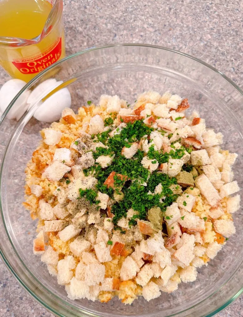 Adding wet ingredients to the cornbread mixture.