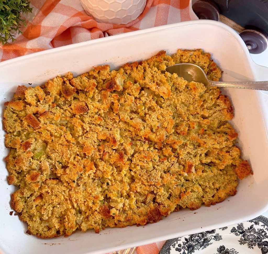 Baked cornbread dressing in baking dish.