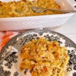 Easy Cornbread dressing on a plate with the casserole dish in the background.