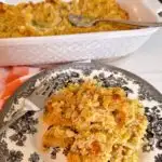 Easy Cornbread dressing on a plate with the casserole dish in the background.