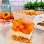 The layered Peach delight dessert cut into a single serving.