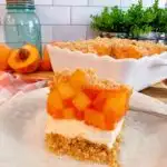 The layered Peach delight dessert cut into a single serving.