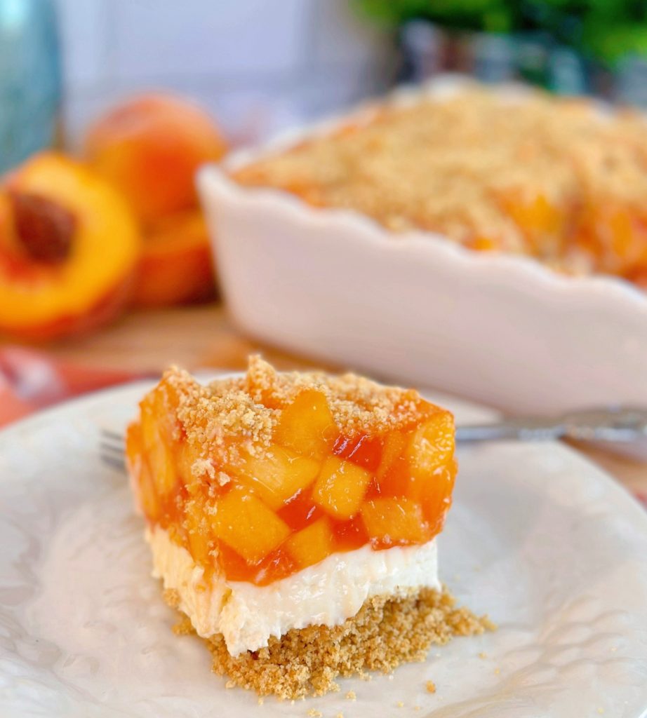 Layered peach delight dessert cut into a single serving. 