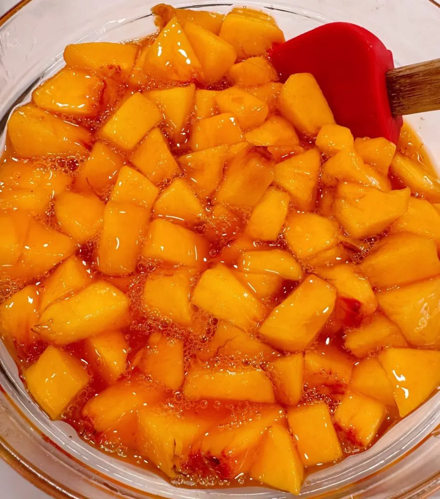 Preparing the peaches for a peach delight dessert.