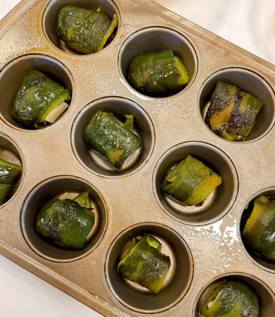 Peppers rolled around cheese cubes and placed in muffin tin.