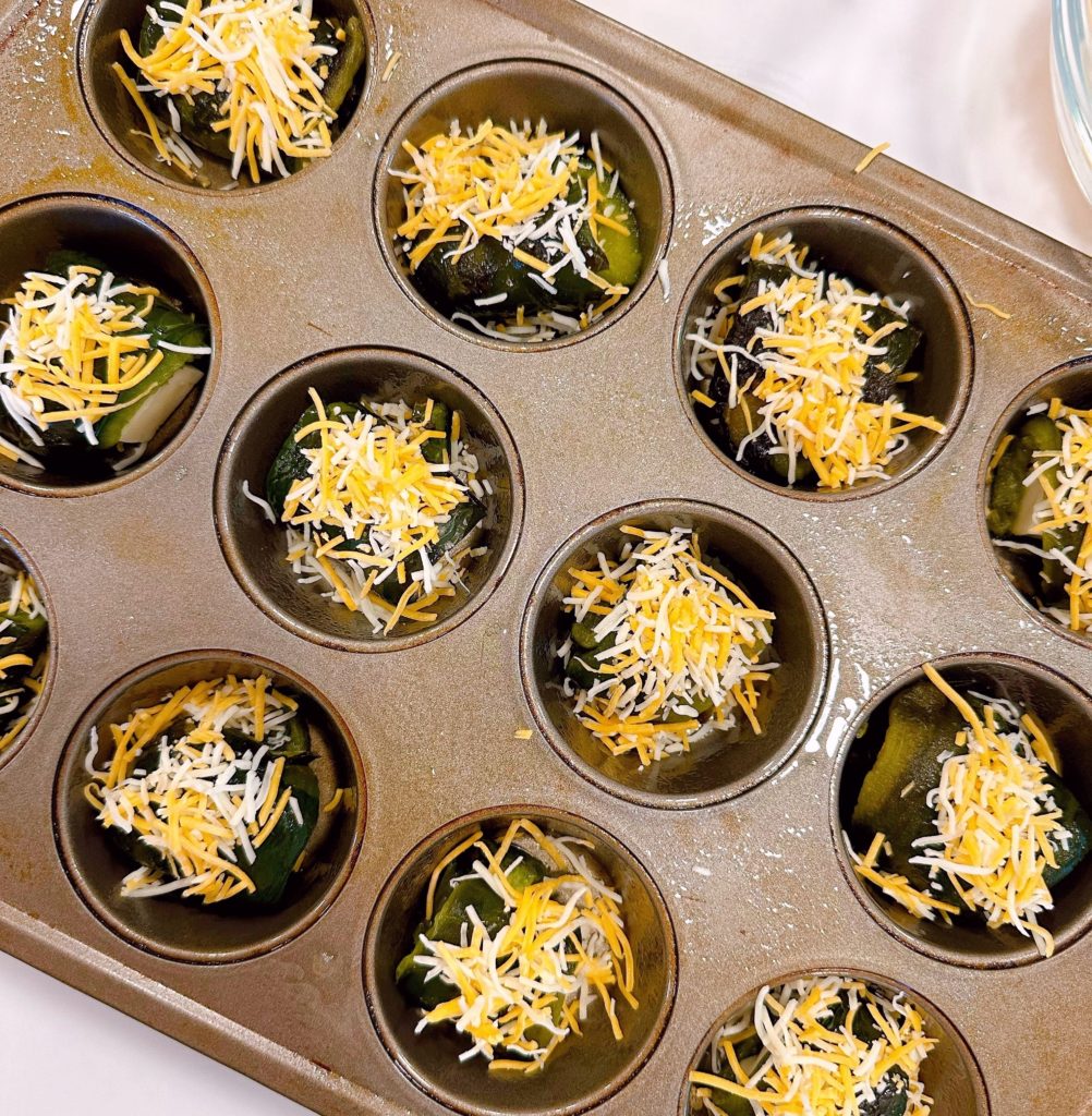 Grated Cheese on top of each stuffed pepper in the muffin tin.