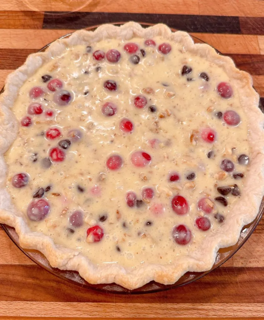 Pie filling is poured into the baked pie crust.