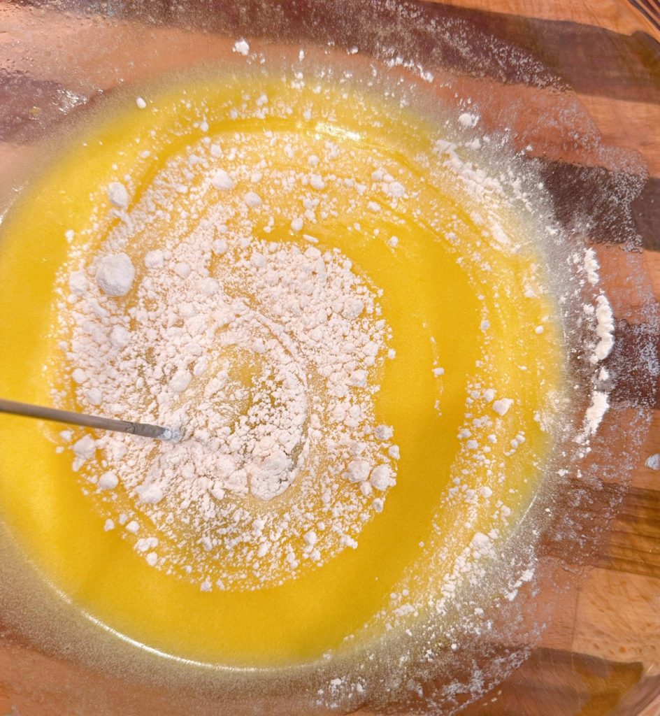 Add flour to the egg and sugar mixture.