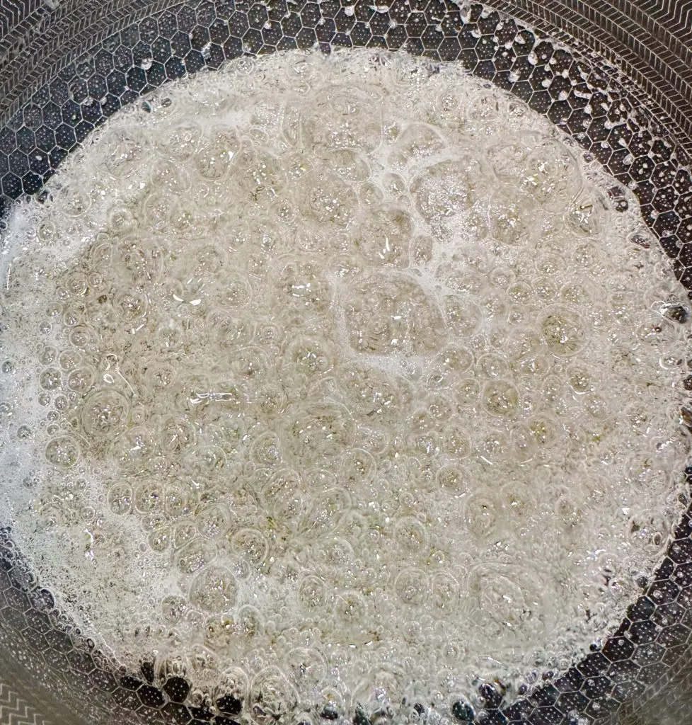 Sugar mixture boiling on stove top.