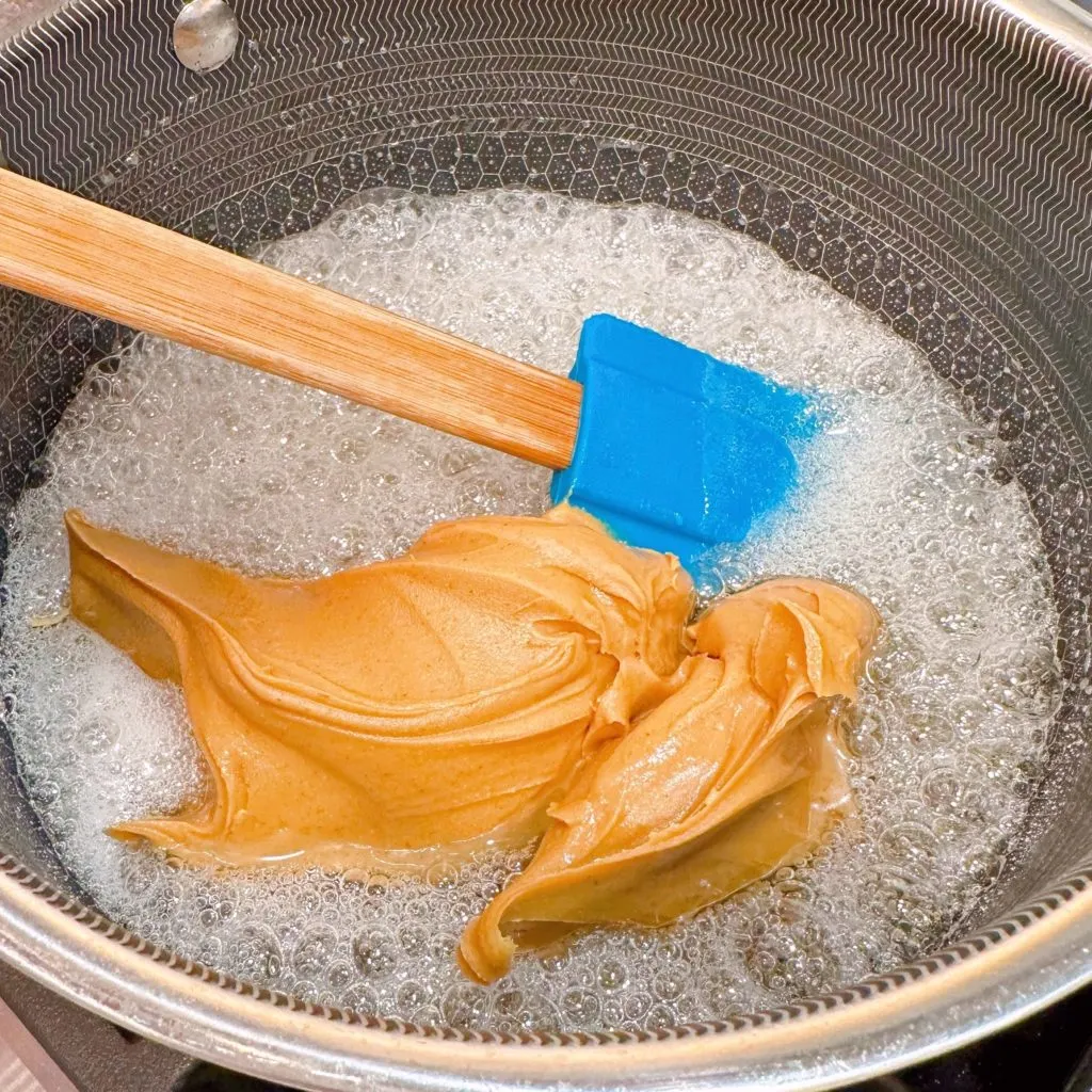 Add peanut butter to the boiling sugar mixture.