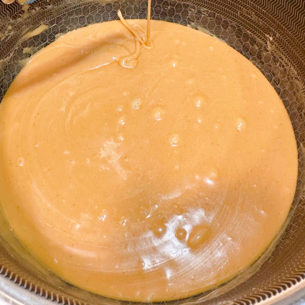 Caramel-peanut butter sauce in a large sauce pan.