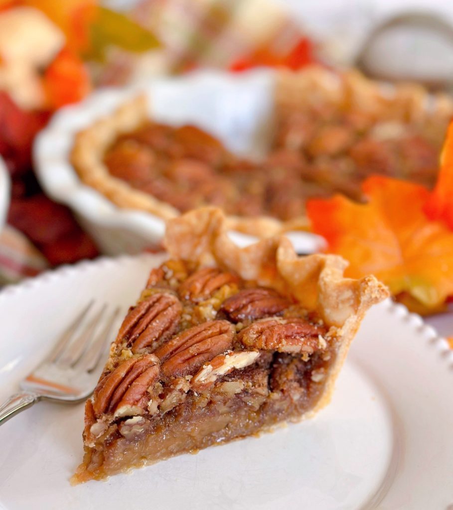 Slice of pecan pie on a dessert plate.