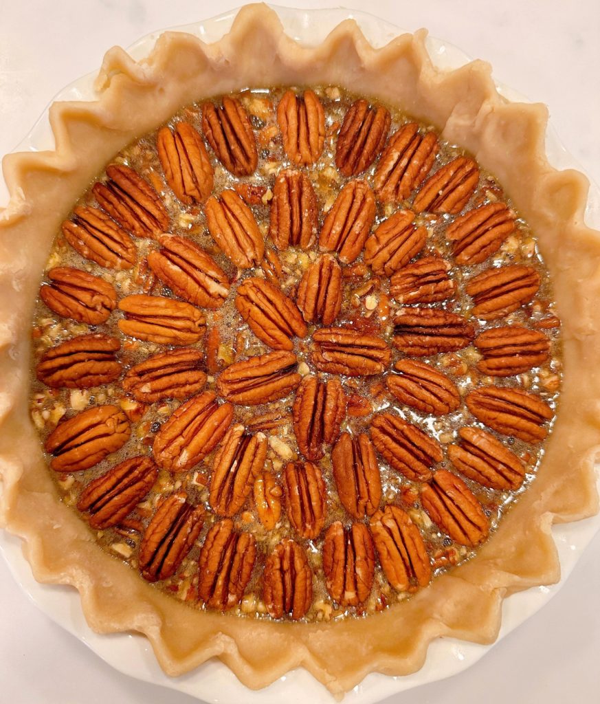 Pecans arranged on top of the pie filling.