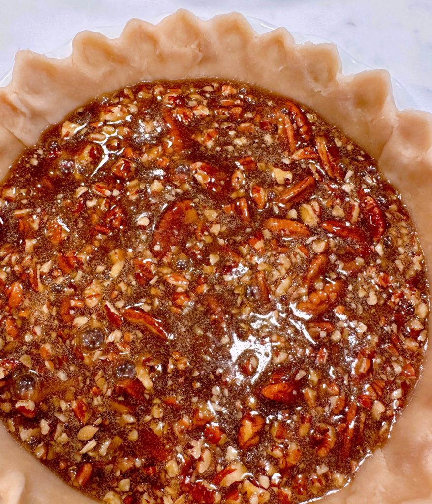 Pecan Pie caramel nut filling in the pie crust.