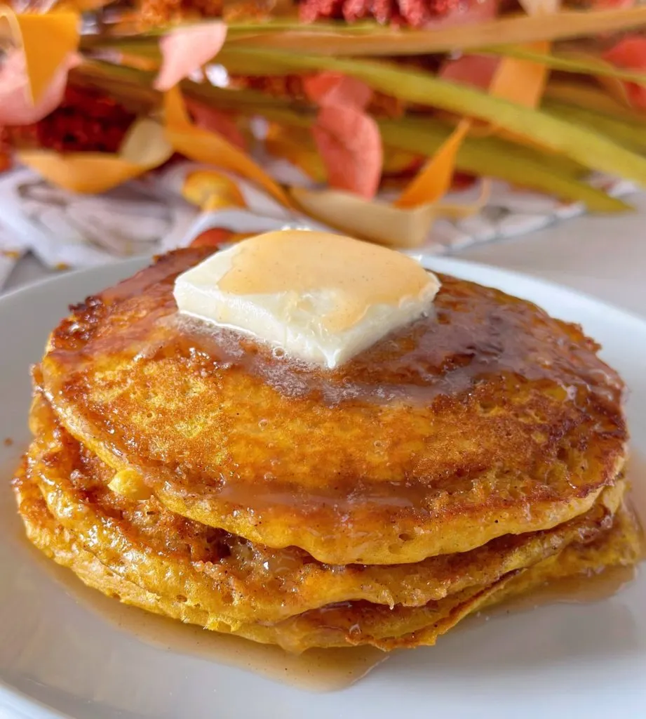 Pumpkin swirl pancakes with syrup and butter.