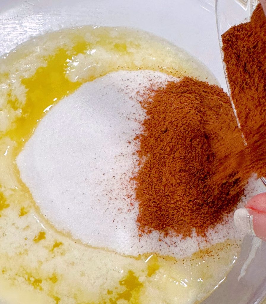 Melted butter with granulated sugar, sugar, and cinnamon.