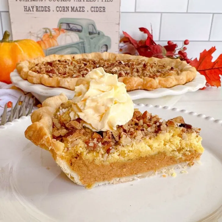 Pumpkin Crunch Pie sliced with a dollop of whipped cream.