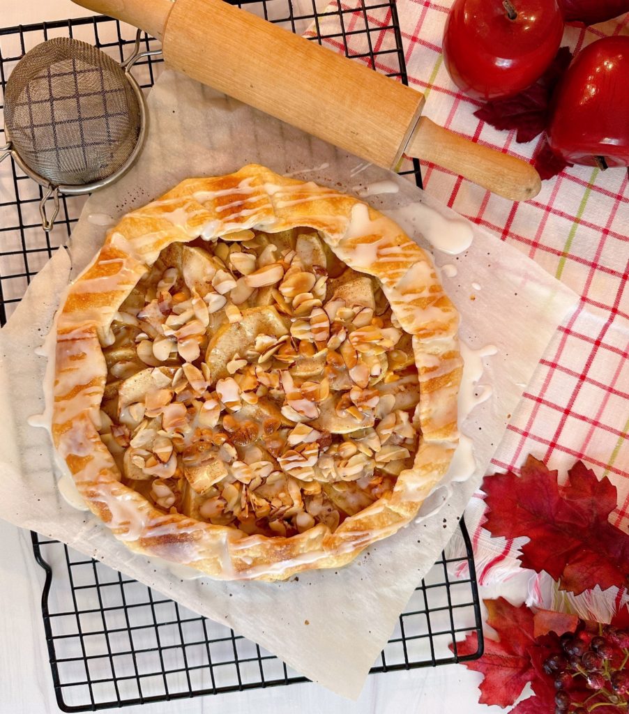 Apple Almond Galette on a cooling rack cooking with the glaze drizzled over the top.