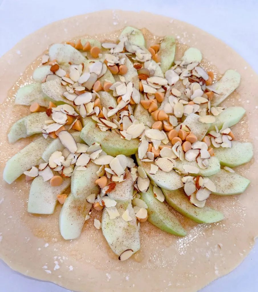 almonds and baking chips sprinkled on top of the apple pie filling.