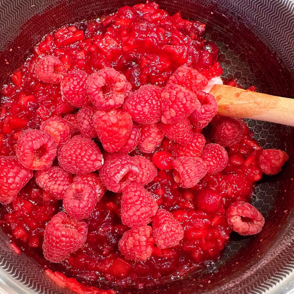 Add in the fresh raspberries to the cranberry base.