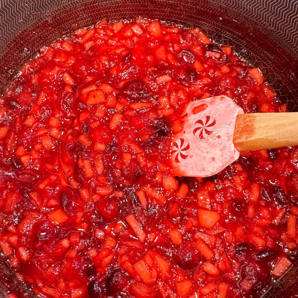 Cooking pears into cranberry chutney.