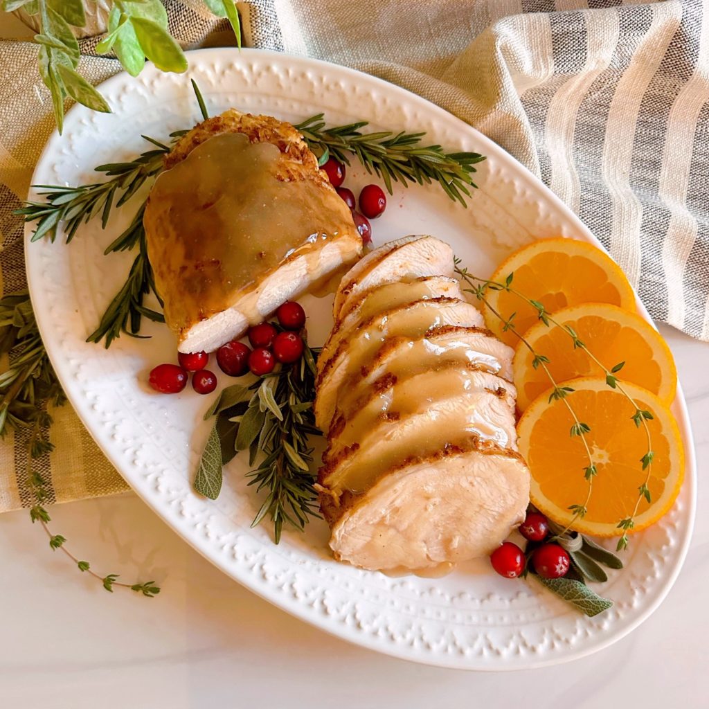 Slow Cooker Turkey Roast with gravy on serving platter.