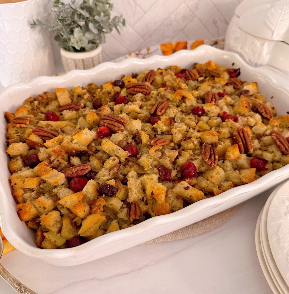 Cranberry Sausage Sour Dough Stuffing in a casserole dish with pecans.