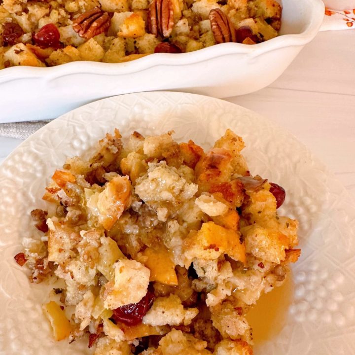 Sausage Cranberry Sourdough Stuffing with gravy on a serving plate.