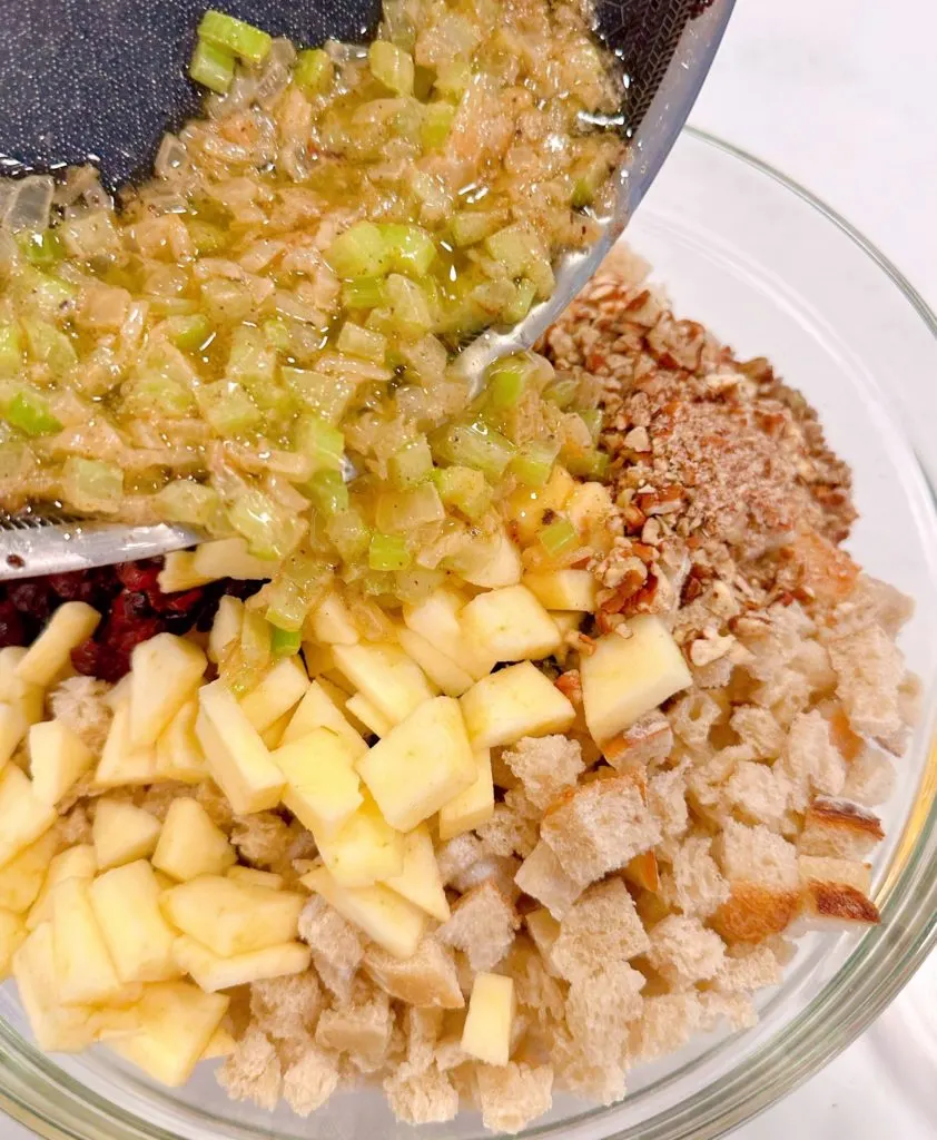 Add sautéed onions and celery to stuffing mixture.