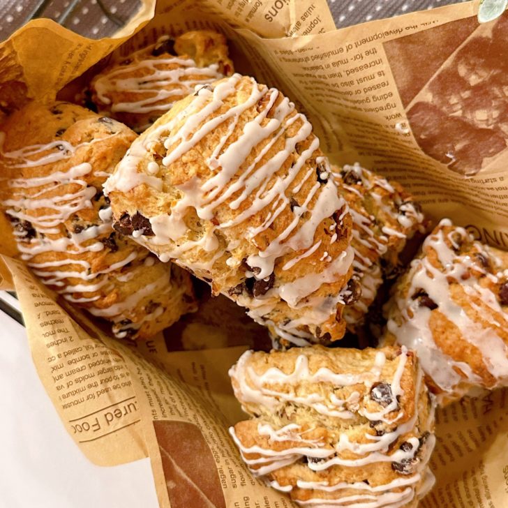 Scones with glaze in a basket.