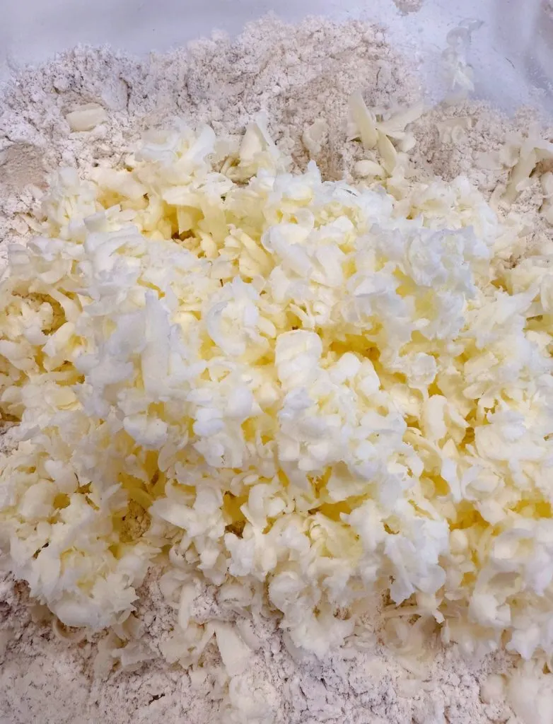 Grated butter added to dry ingredients.