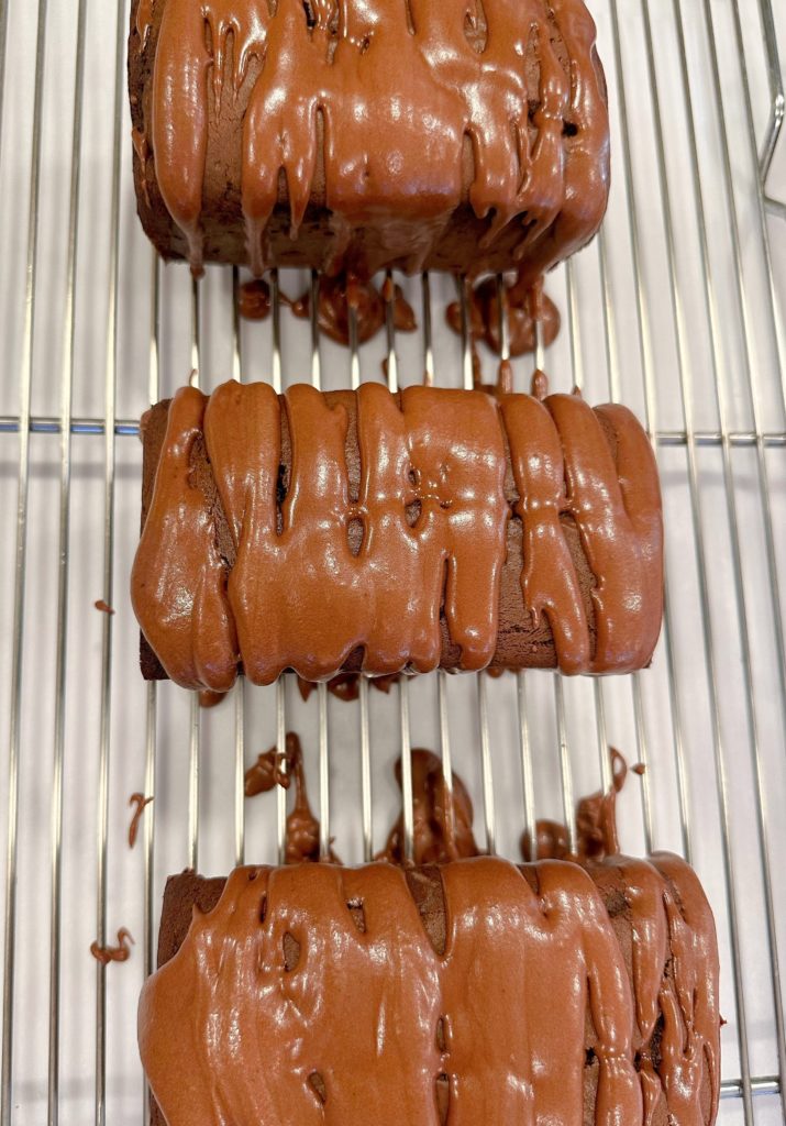 Drizzle the icing over the top of each chocolate loaf.