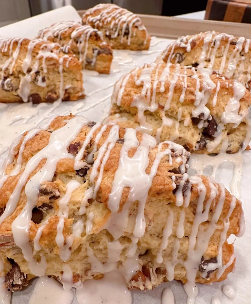 Chocolate chip pecan scones with drizzled glaze.